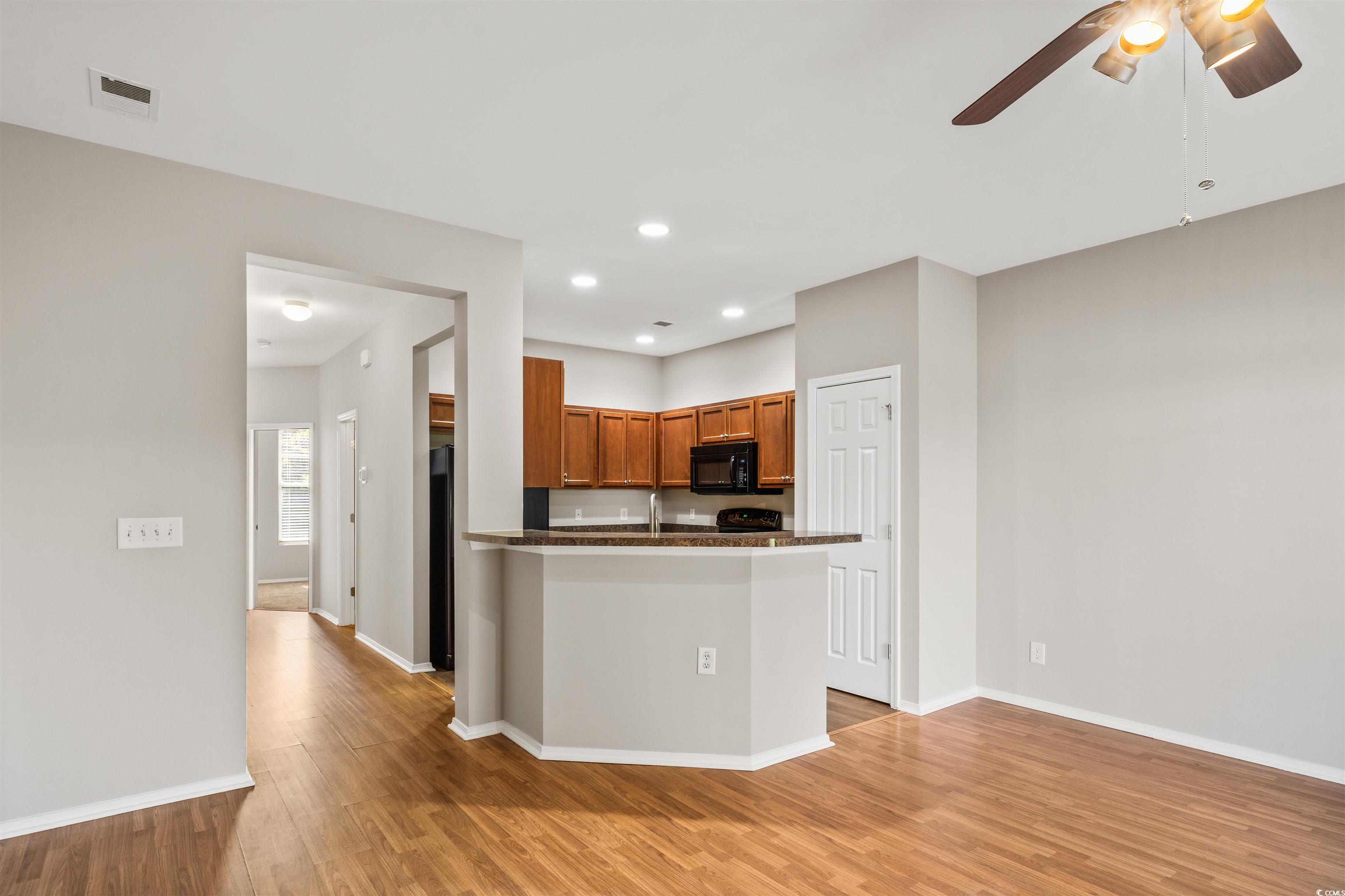 350 Kiskadee Loop, Unit B Conway, SC 29526 - Photo 8 of 40 Kitchen with ceiling fan, sink, and light hardwood