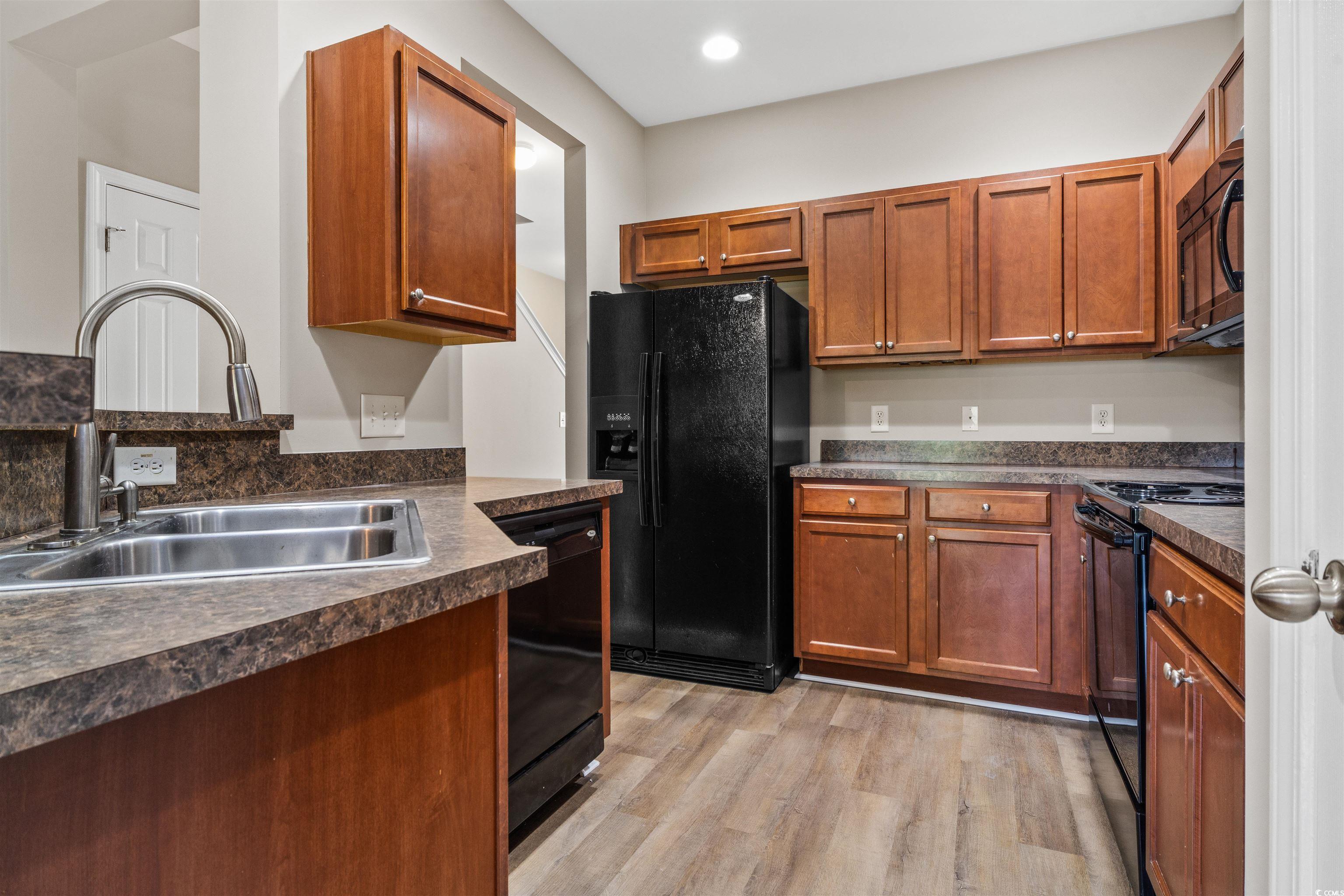 350 Kiskadee Loop, Unit B Conway, SC 29526 - Photo 9 of 40 Kitchen with black appliances, sink, and light har