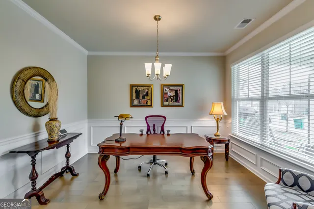 a view of a workspace with furniture and a window