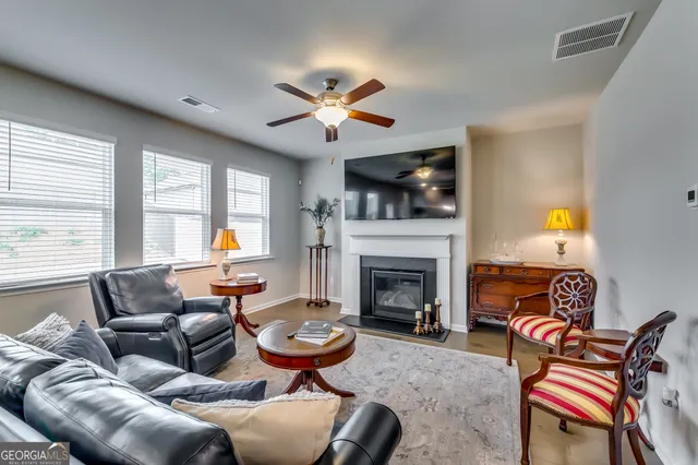 a living room with furniture and a view of kitchen