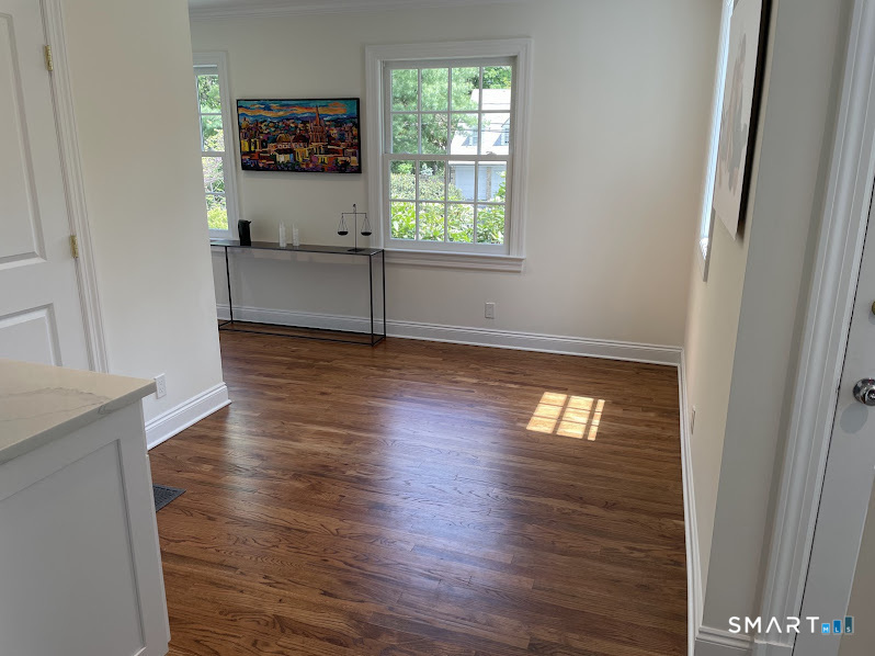9 Tory Hole Road Darien, CT 06820 - Photo 12 of 33 an empty room with wooden floor and windows