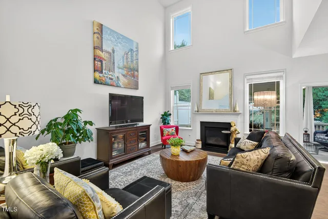a living room with fireplace furniture and a chandelier