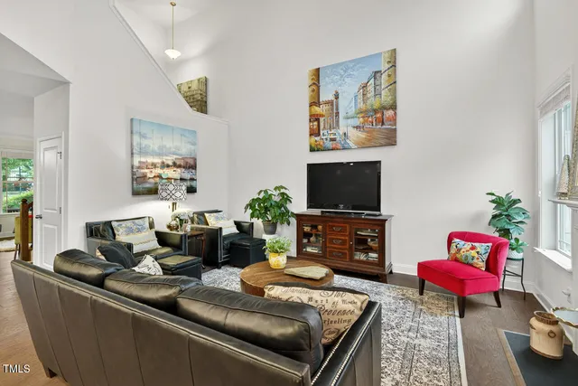 a living room with furniture fireplace and potted plant