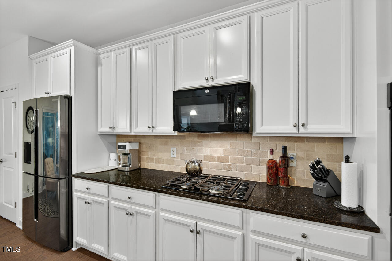 127 Willow View Lane Apex, NC 27539 - Photo 15 of 39 a kitchen with stainless steel appliances granite countertop white cabinets a refrigerator and a sink