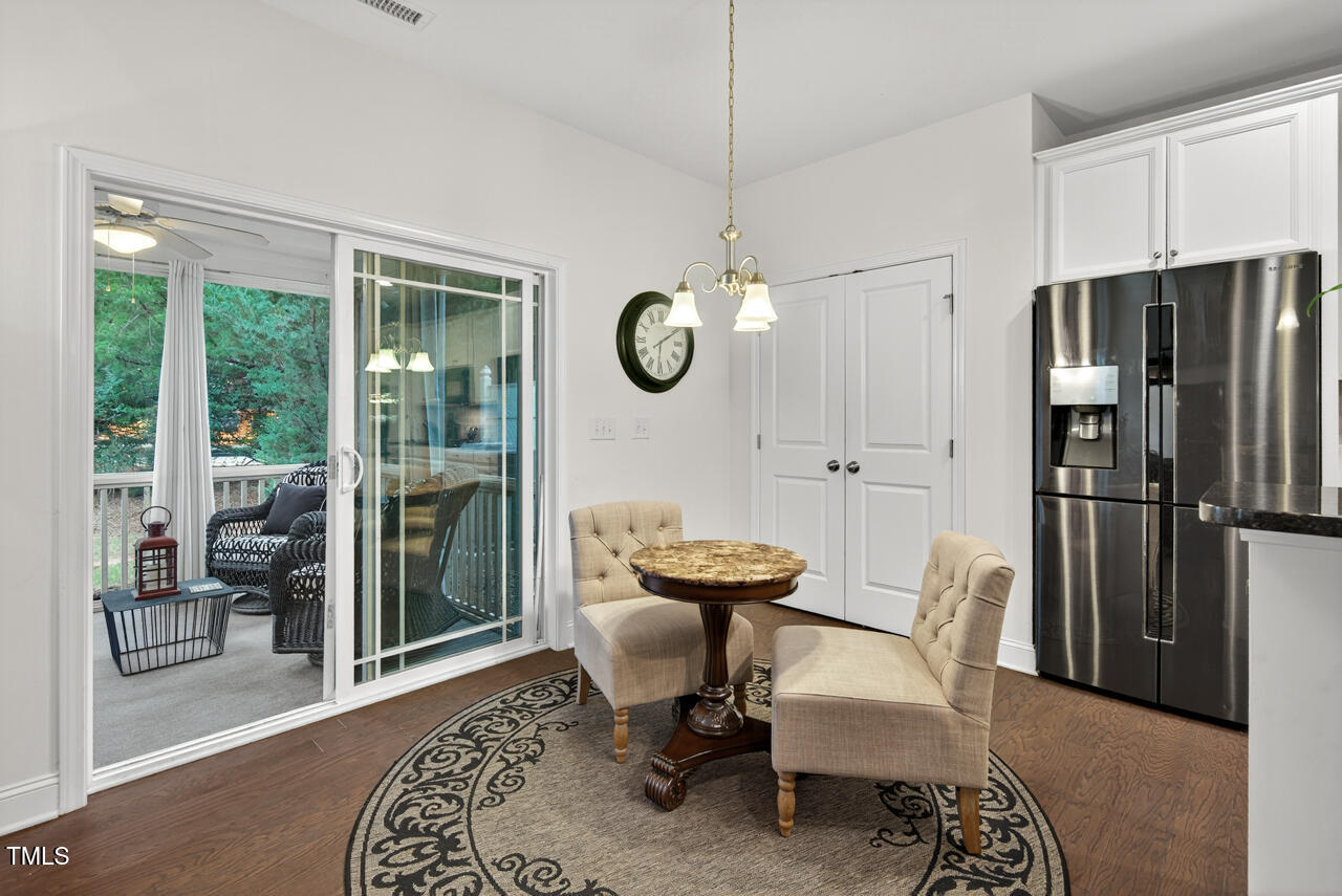 127 Willow View Lane Apex, NC 27539 - Photo 18 of 39 a view of a dining room with furniture wooden floor and a chandelier