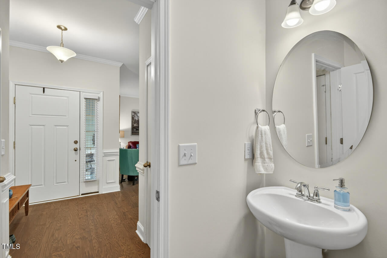 127 Willow View Lane Apex, NC 27539 - Photo 19 of 39 a bathroom with a sink a mirror and a shower