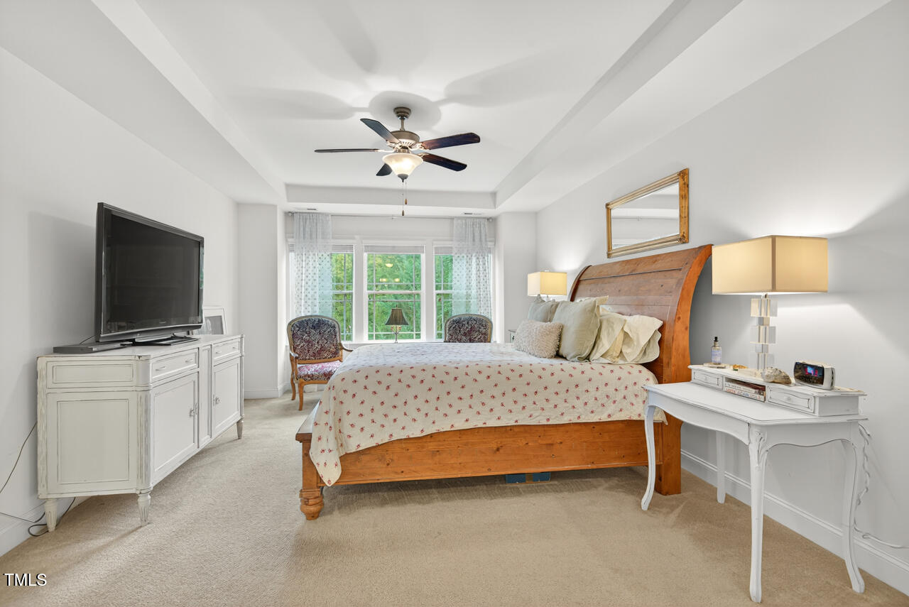 127 Willow View Lane Apex, NC 27539 - Photo 22 of 39 a bedroom with a bed and a flat screen tv