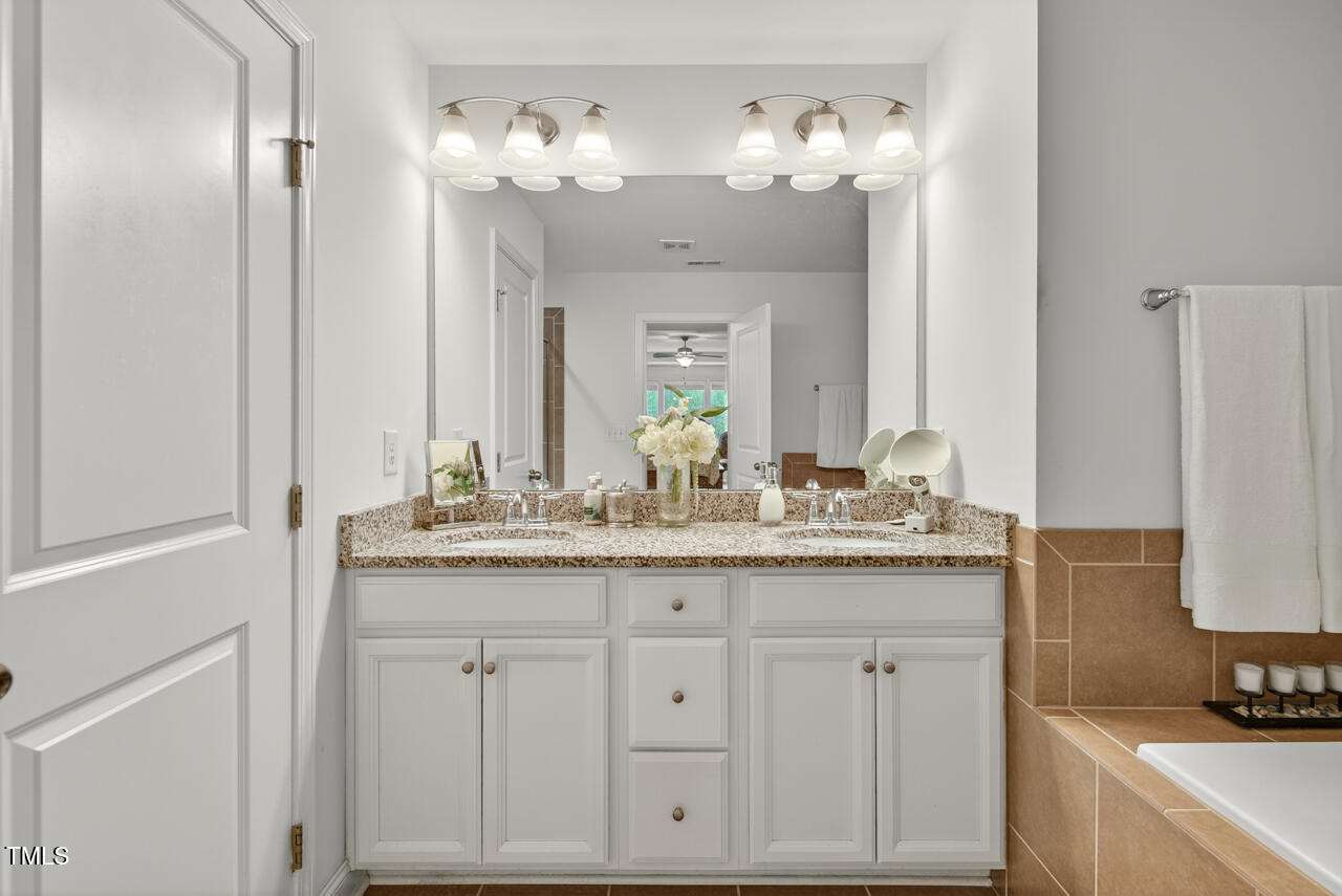 127 Willow View Lane Apex, NC 27539 - Photo 24 of 39 a bathroom with a sink and a mirror