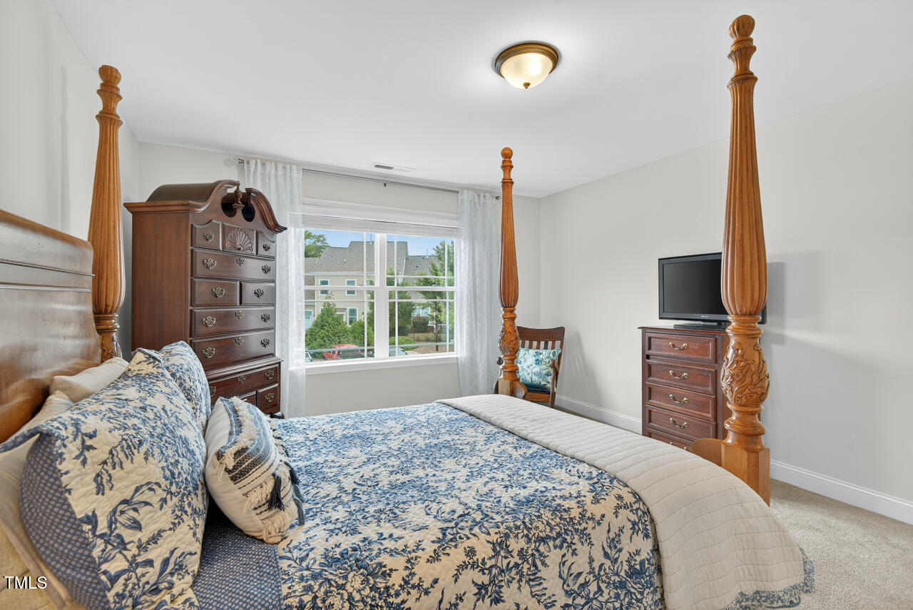 127 Willow View Lane Apex, NC 27539 - Photo 28 of 39 a bedroom with a bed and wooden floor