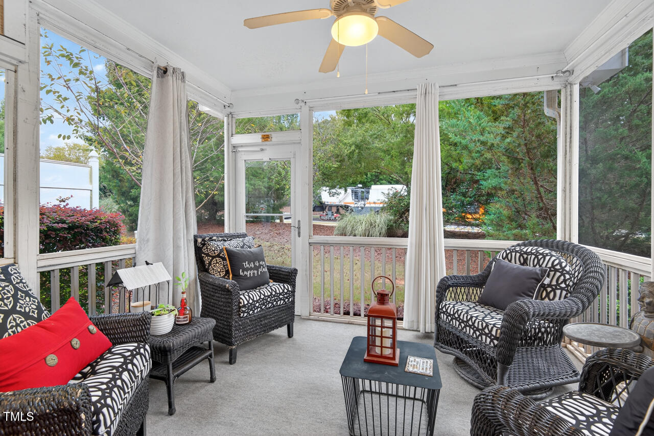 127 Willow View Lane Apex, NC 27539 - Photo 32 of 39 a living room with furniture and a floor to ceiling window