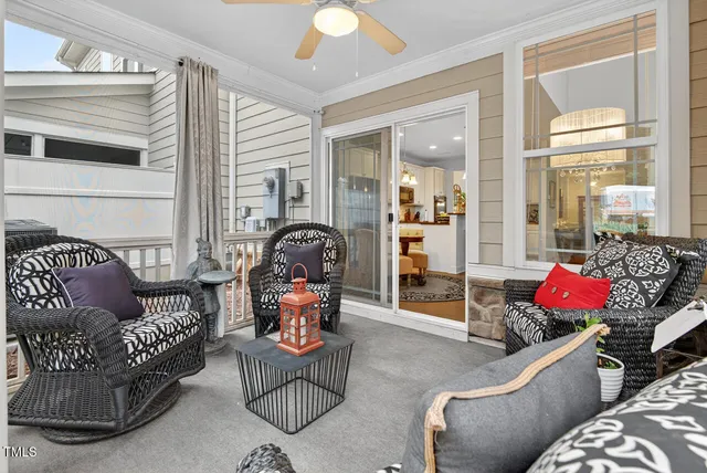 a living room with furniture and a floor to ceiling window