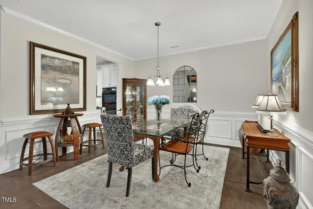 a living room with furniture a rug and a wall painting