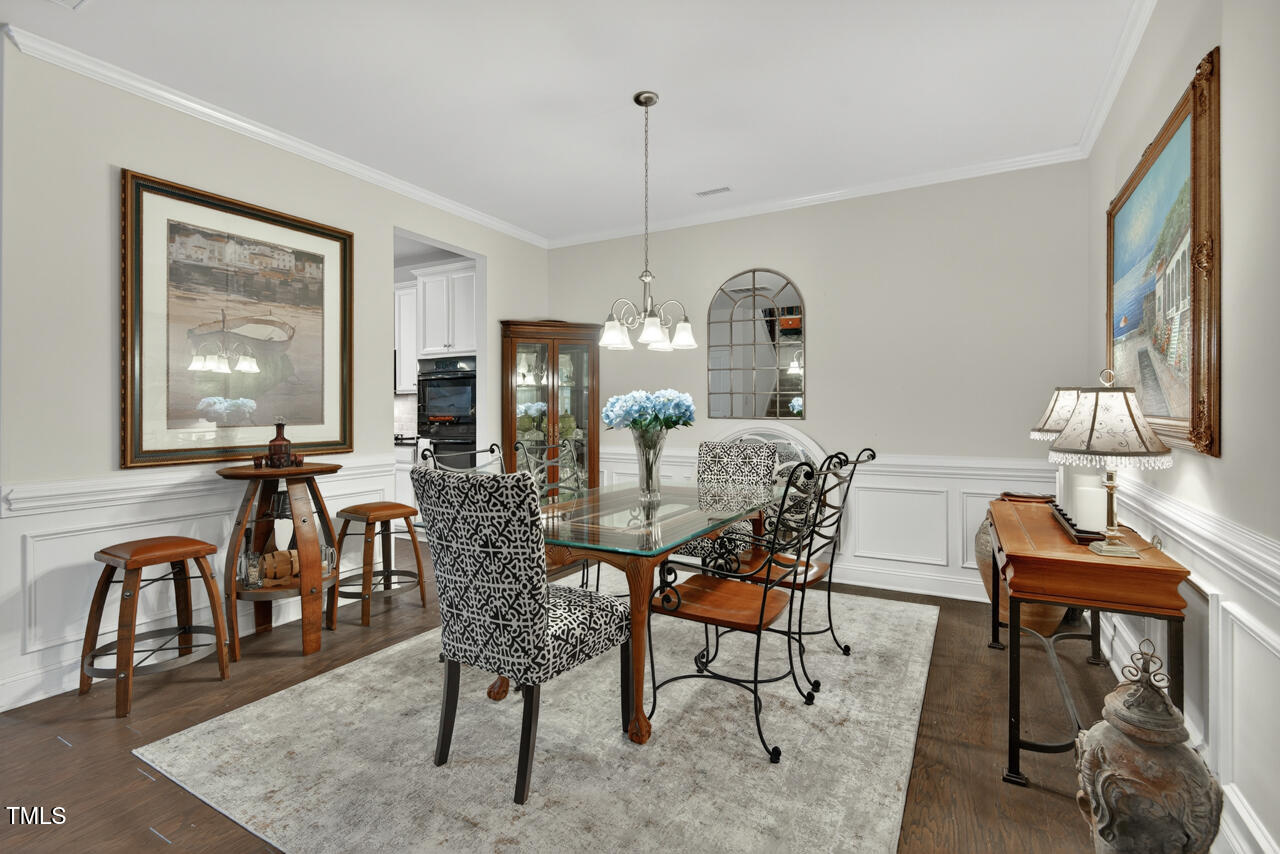 127 Willow View Lane Apex, NC 27539 - Photo 7 of 39 a dining room with furniture a chandelier and window