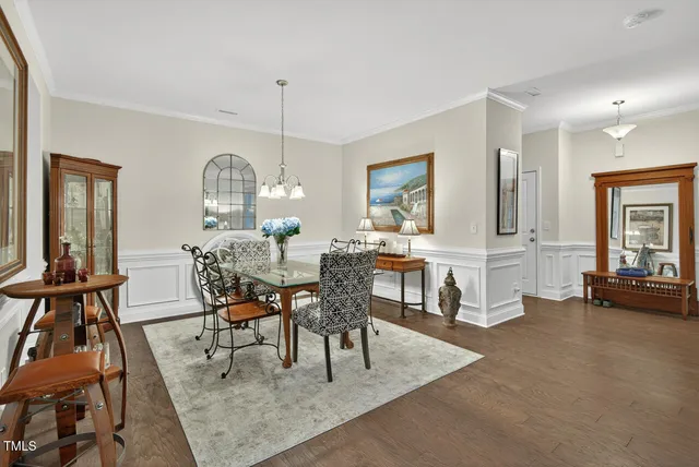 a dining room with furniture a chandelier and window