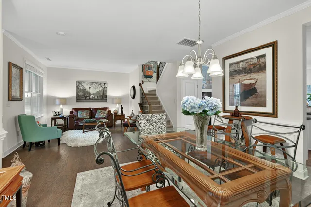 a view of a dining room with furniture and a chandelier