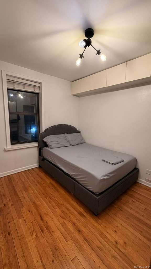 8305 98th Street, Unit 3C Queens, NY 11421 - Photo 8 of 19 a bedroom with a bed and a ceiling fan