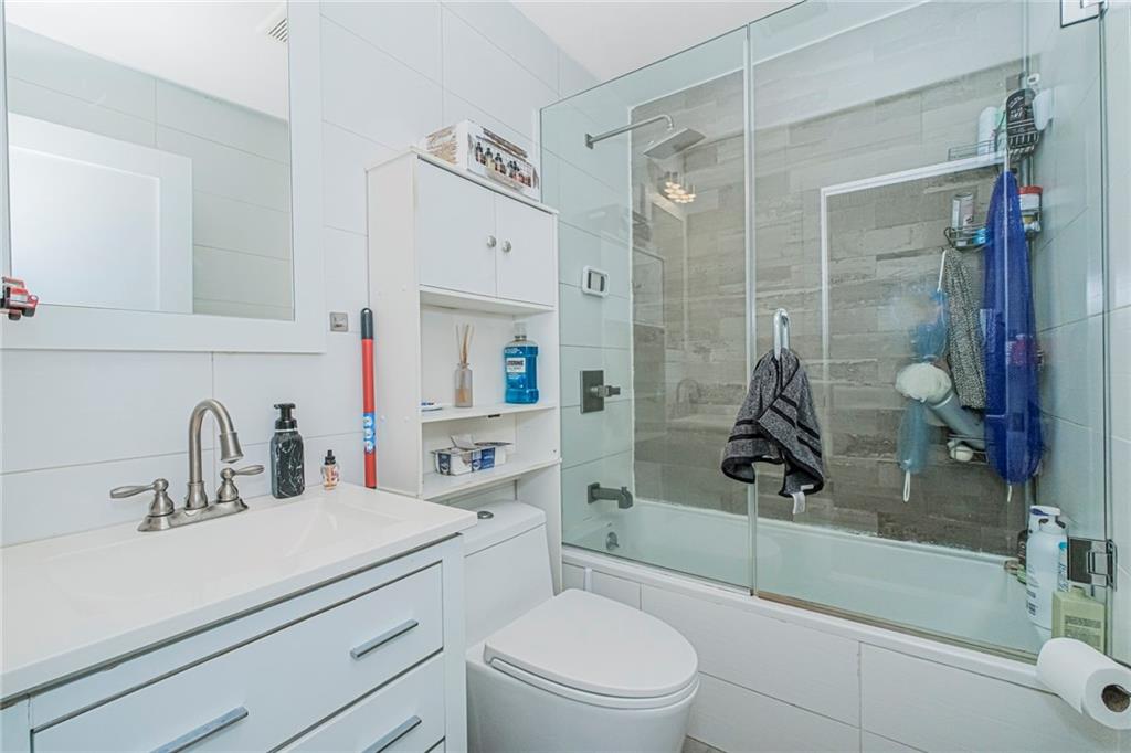 934 Jefferson Avenue Brooklyn, NY 11221 - Photo 12 of 36 a bathroom with a sink a toilet and shower