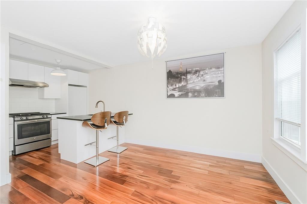 934 Jefferson Avenue Brooklyn, NY 11221 - Photo 19 of 36 a kitchen with a stove and a wooden floor