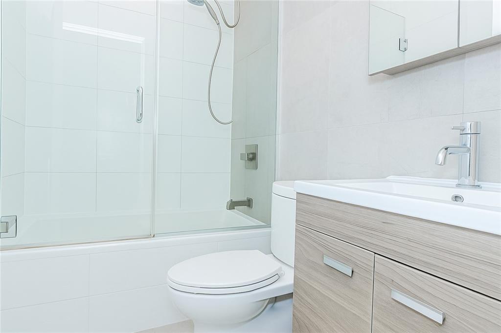 934 Jefferson Avenue Brooklyn, NY 11221 - Photo 23 of 36 a bathroom with a sink a toilet and shower