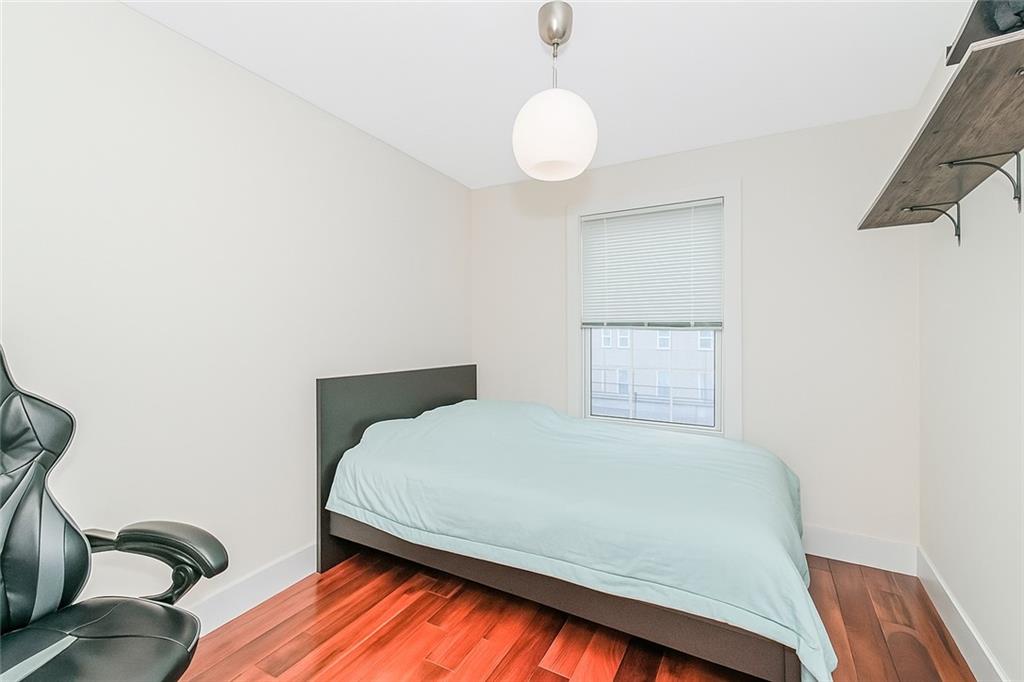 934 Jefferson Avenue Brooklyn, NY 11221 - Photo 26 of 36 a bedroom with a bed and wooden floor