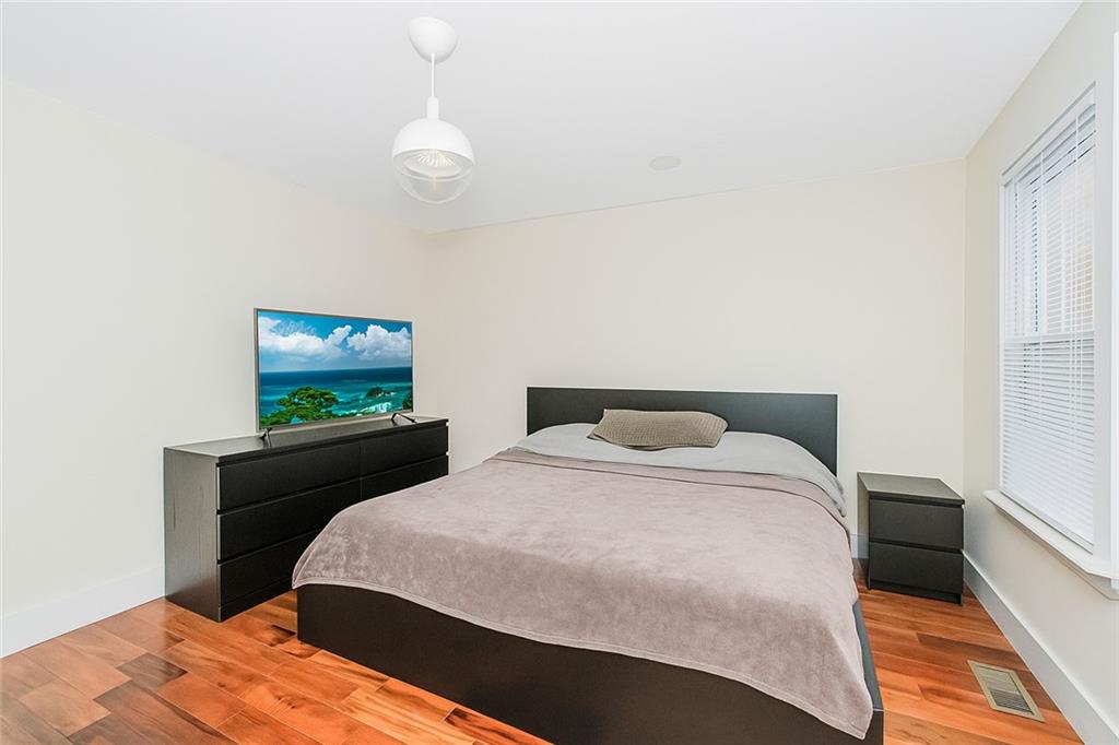 934 Jefferson Avenue Brooklyn, NY 11221 - Photo 8 of 36 a bedroom with a bed and a flat screen tv