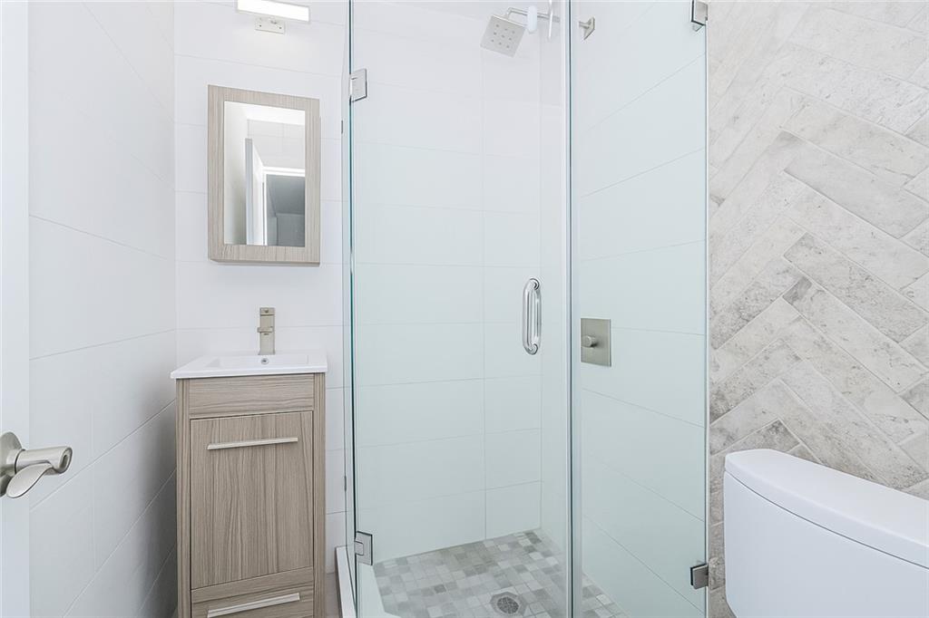 934 Jefferson Avenue Brooklyn, NY 11221 - Photo 10 of 36 a bathroom with a sink a toilet and shower