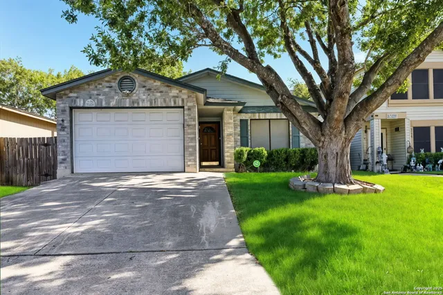 a front view of a house with a garden and yard