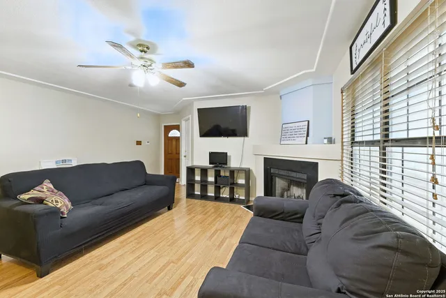 a living room with furniture a fireplace and a flat screen tv