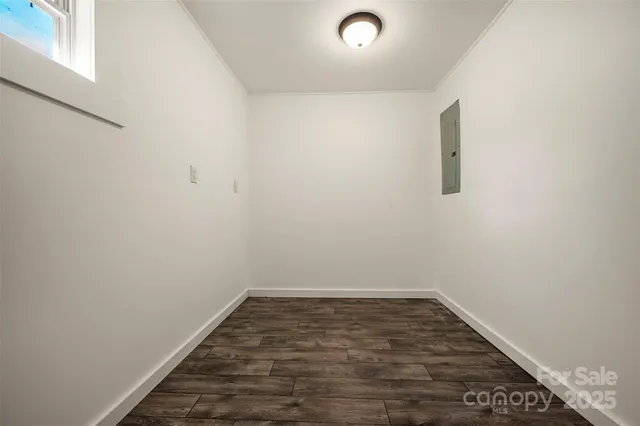 a view of a room with wooden floor and white walls