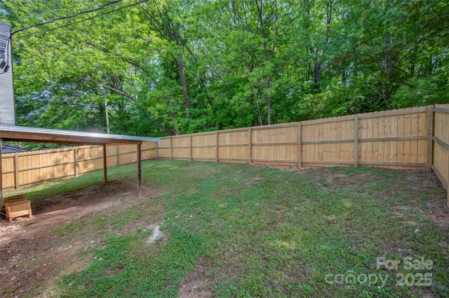 a view of an house with backyard space and garden