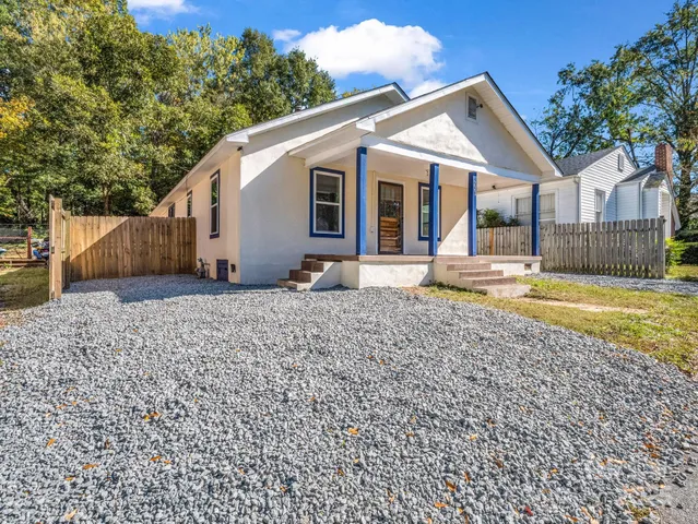 a view of a house with a yard and sitting area