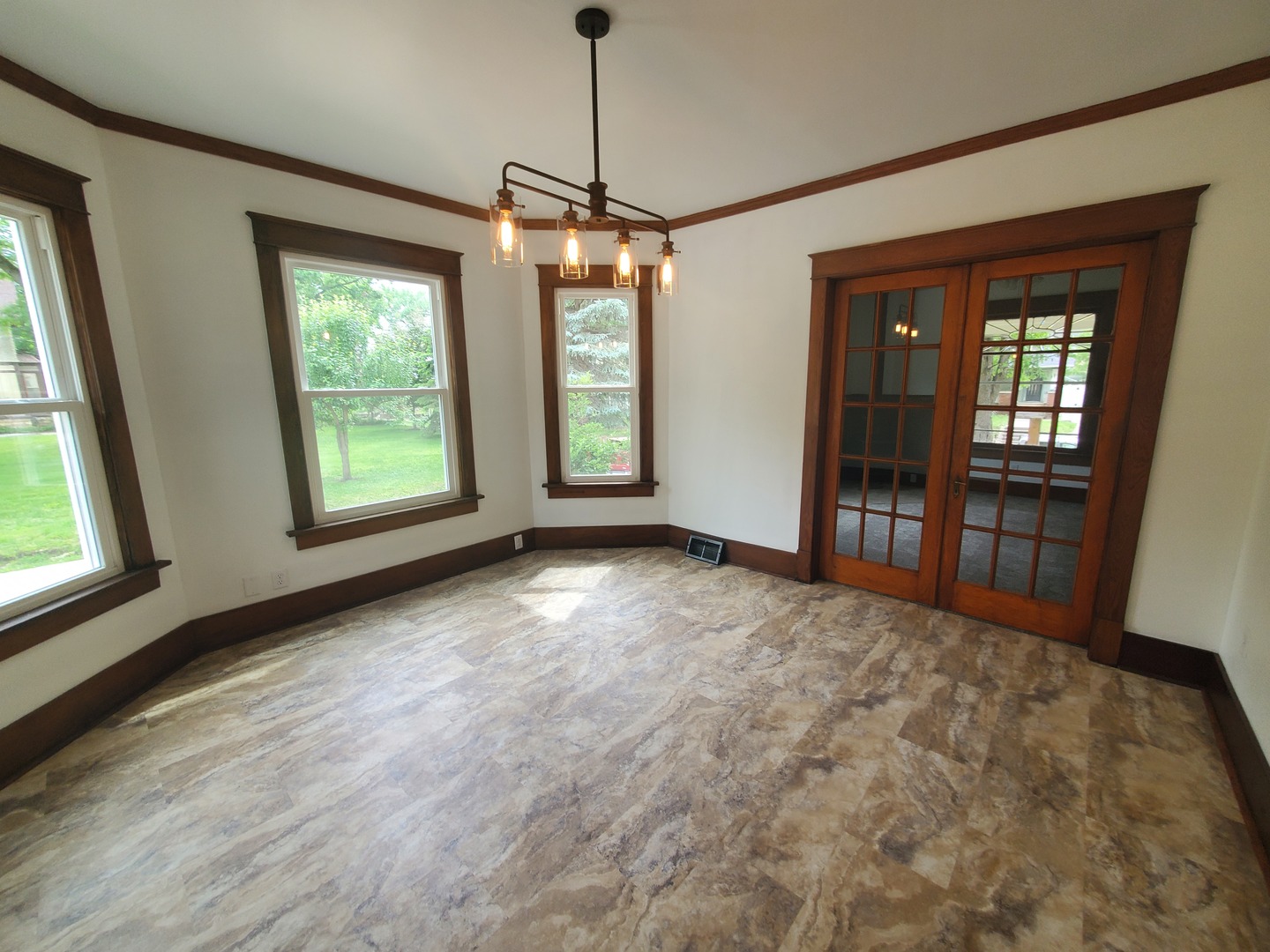 712 3rd Street Moline, IL 61265 - Photo 19 of 29 a view of an empty room with glass door and wooden floor