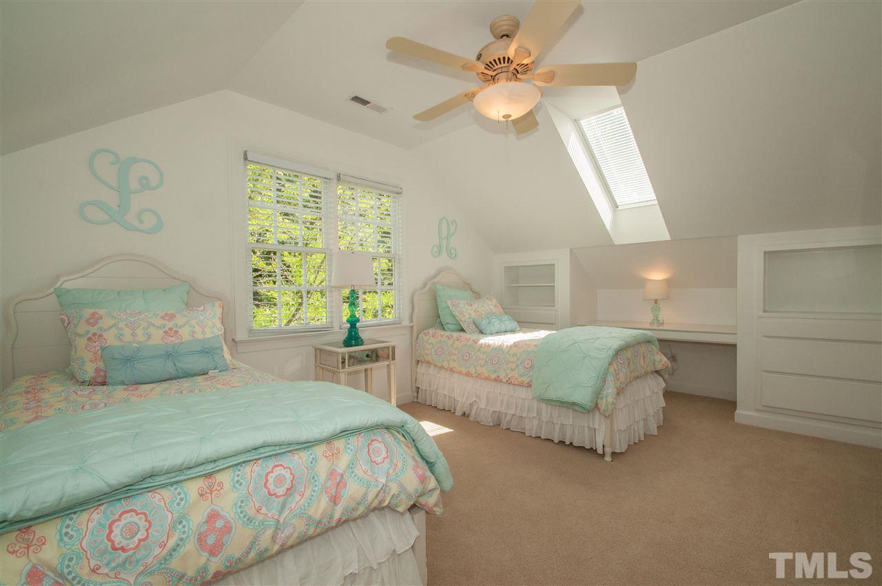 408 Chatterson Drive Raleigh, NC 27615 - Photo 17 of 25 a bedroom with a large bed and a chandelier