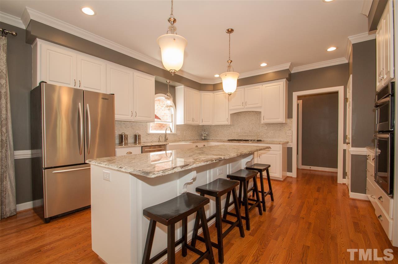 408 Chatterson Drive Raleigh, NC 27615 - Photo 3 of 25 a kitchen with stainless steel appliances granite countertop a refrigerator a sink dishwasher a stove and a refrigerator with wooden floor
