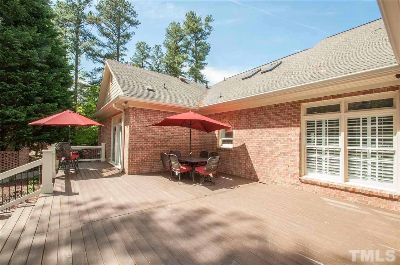 408 Chatterson Drive Raleigh, NC 27615 - Photo 21 of 25 a view of a patio with a table and chairs under an umbrella
