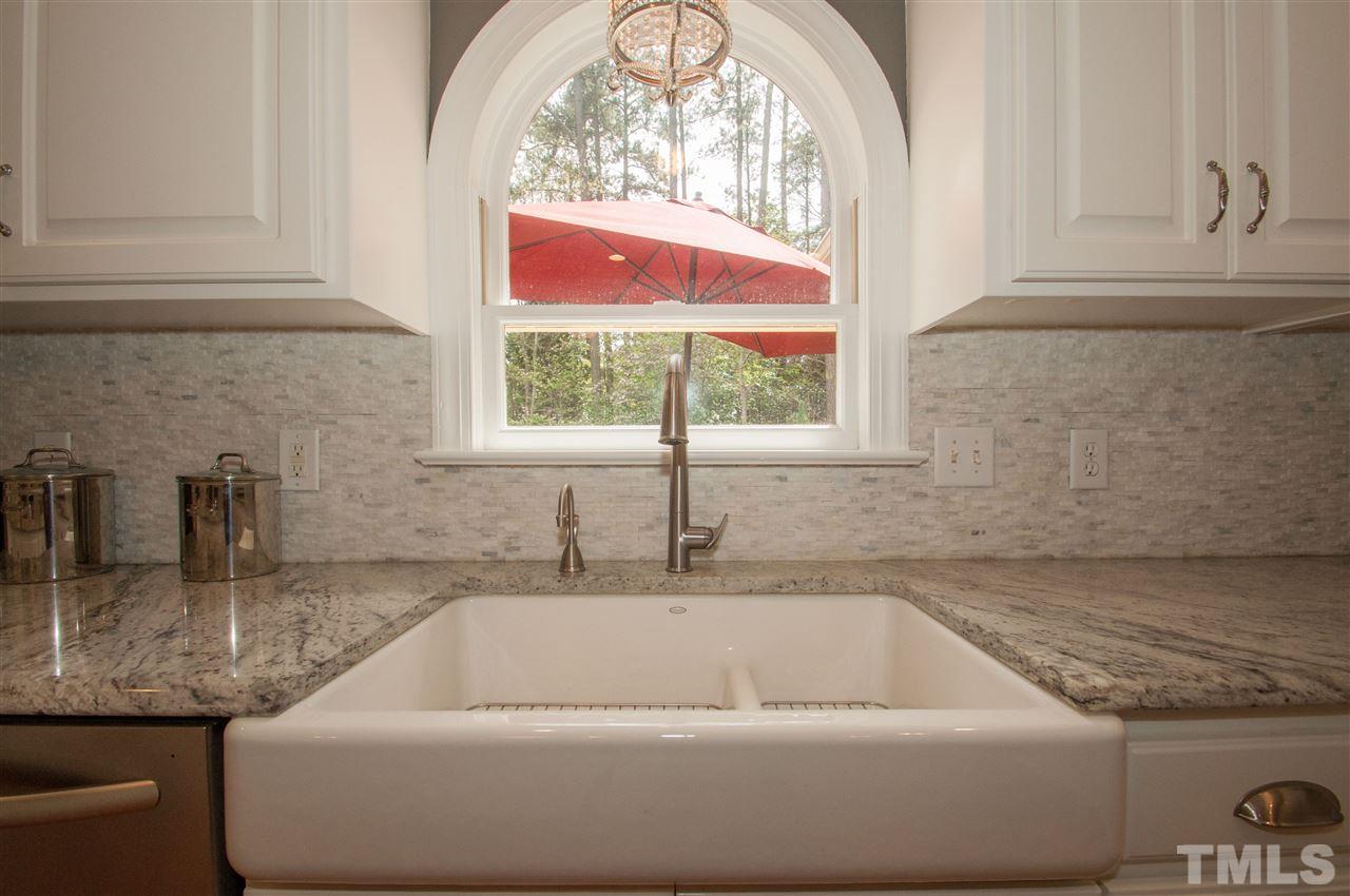 408 Chatterson Drive Raleigh, NC 27615 - Photo 4 of 25 a bathroom with a granite countertop a sink and a window