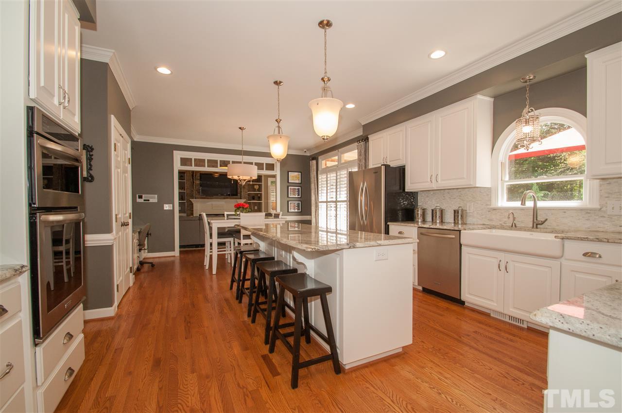 408 Chatterson Drive Raleigh, NC 27615 - Photo 5 of 25 a kitchen with stainless steel appliances a dining table chairs stove and cabinets