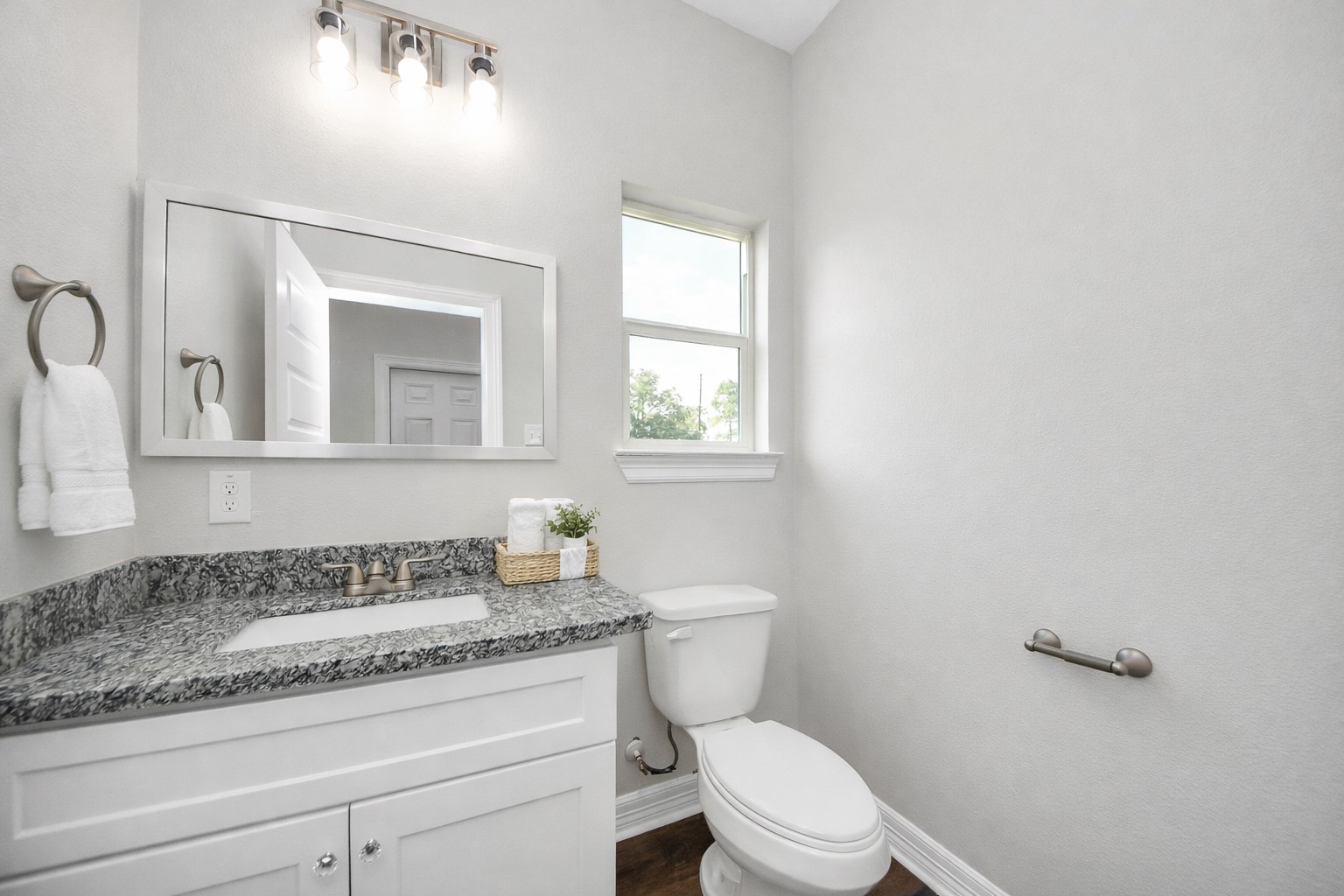 414 North 4th Street Beasley, TX 77417 - Photo 12 of 26 The first-floor half bathroom offers a practical and stylish space, easily accessible for guests and family while blending seamlessly with the home’s overall design.