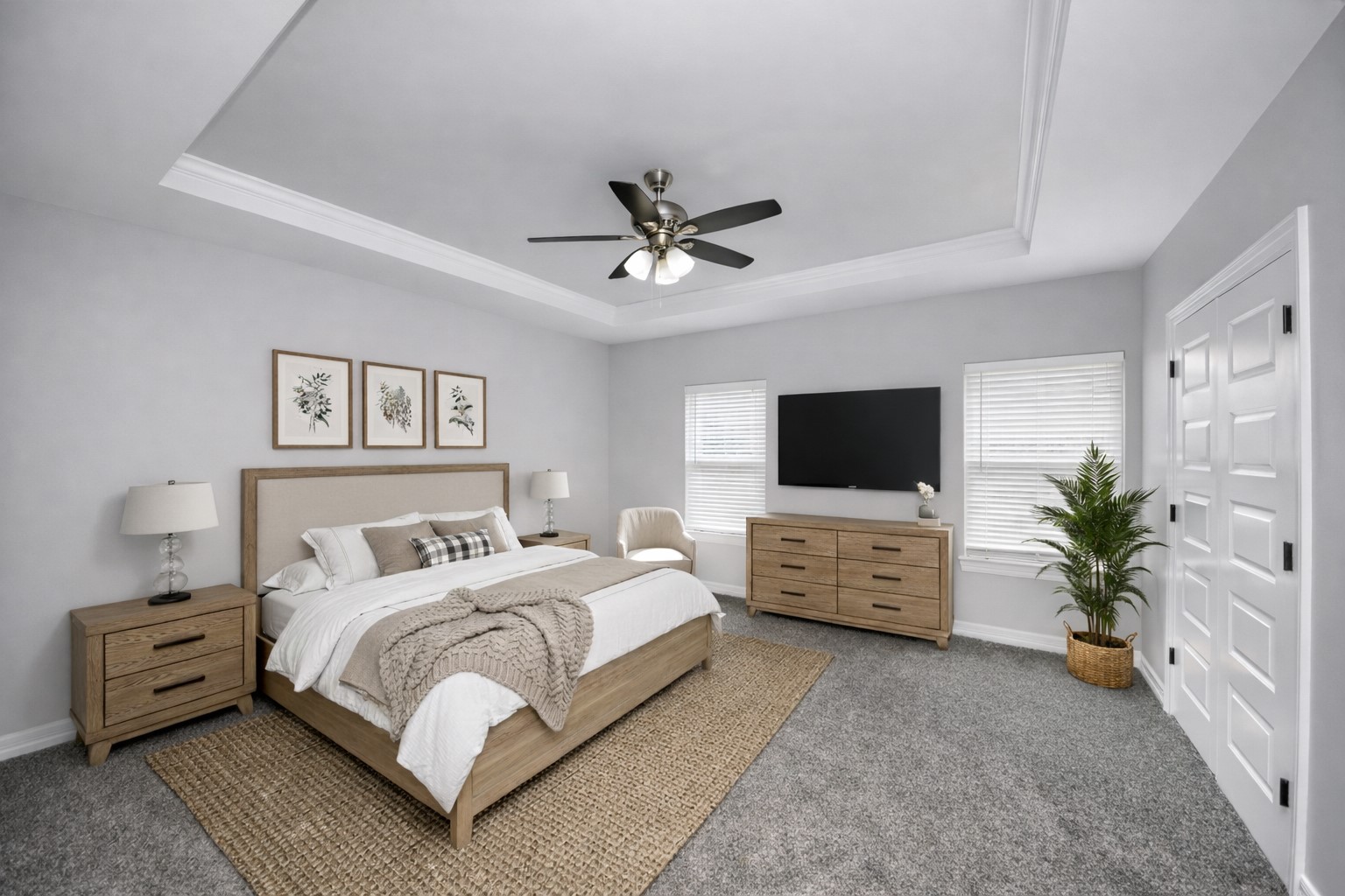 414 North 4th Street Beasley, TX 77417 - Photo 14 of 26 Step into the stunning primary suite, a spacious retreat designed for both comfort and style, offering plenty of room for all your favorite bedroom furniture. Flooded with natural light from large windows, this serene space is elevated by elegant crown molding, a sophisticated tray ceiling, and a stylish ceiling fan - virtually staged.