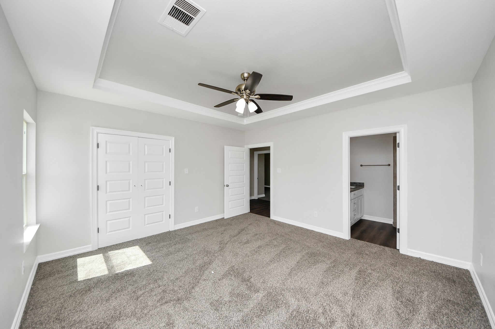 414 North 4th Street Beasley, TX 77417 - Photo 15 of 26 Here's another view of the spacious primary suite, a true sanctuary featuring a spacious closet with plenty of storage for all your wardrobe essentials. The attached ensuite bathroom is designed with both style and convenience in mind to meet your everyday needs.