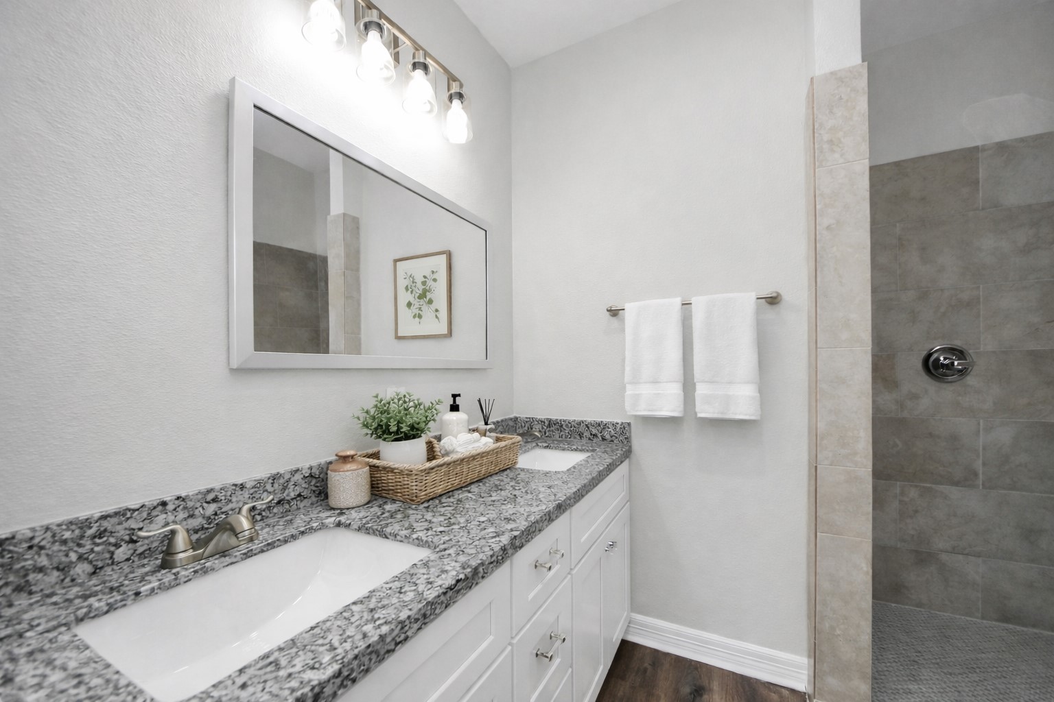 414 North 4th Street Beasley, TX 77417 - Photo 16 of 26 The primary bathroom combines elegance and practicality, showcasing a stunning mud-set shower with a rainfall showerhead, a spacious granite vanity with dual sinks, and plenty of cabinet space to keep everything organized and within reach.