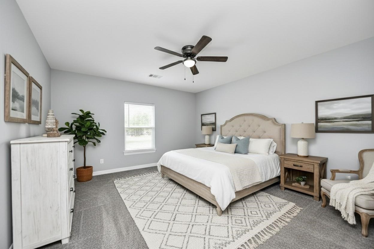 414 North 4th Street Beasley, TX 77417 - Photo 18 of 26 This cozy oversized secondary bedroom exudes warmth with a large window that fills the space with natural light, neutral-toned walls, a spacious closet for ample storage, and plush carpeting for added comfort - virtually staged.