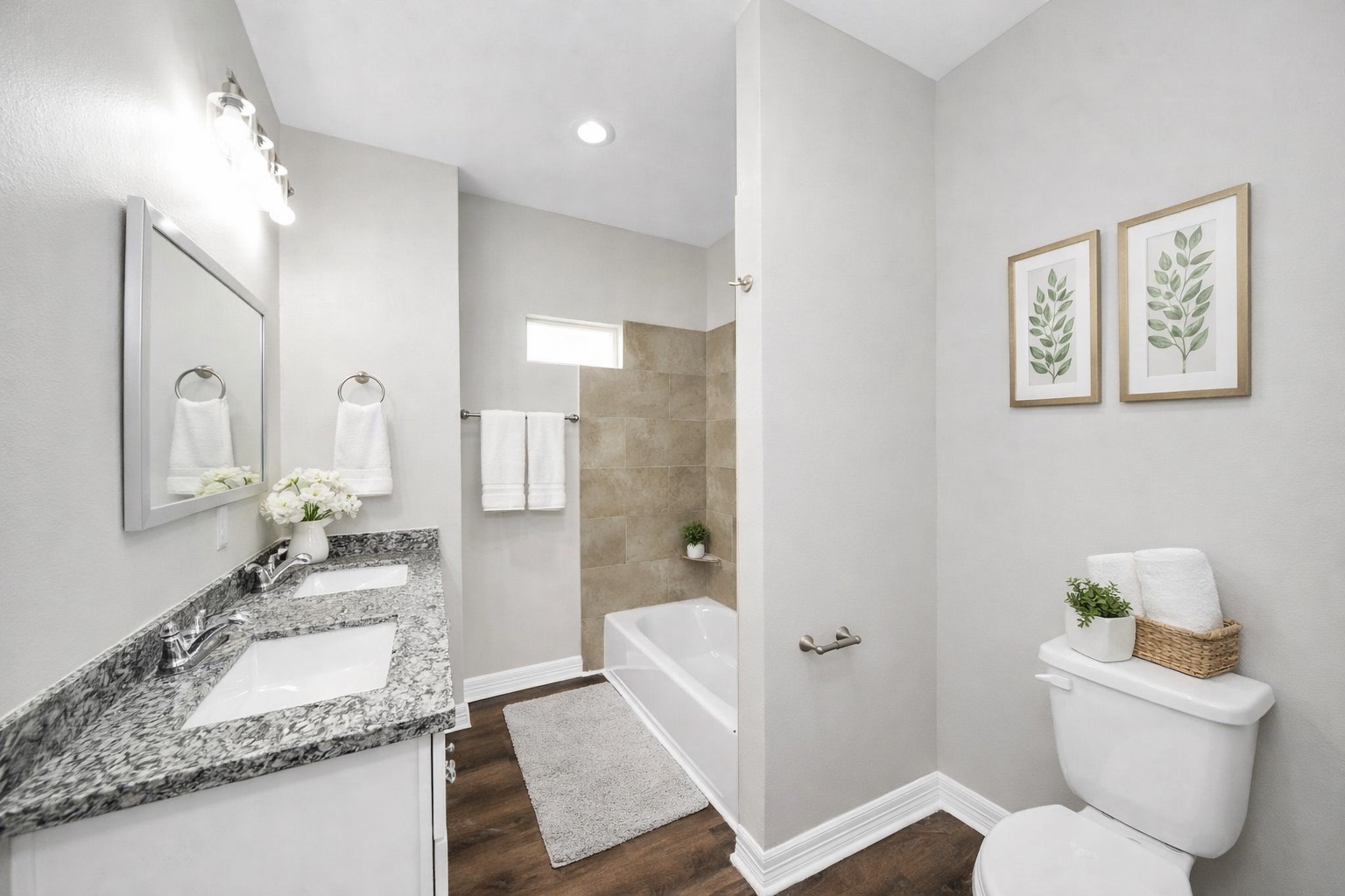 414 North 4th Street Beasley, TX 77417 - Photo 19 of 26 This secondary hall bathroom is both stylish and functional, featuring durable LVP flooring, granite countertops with dual sinks, and plenty of storage space—perfect for family use and guests alike.