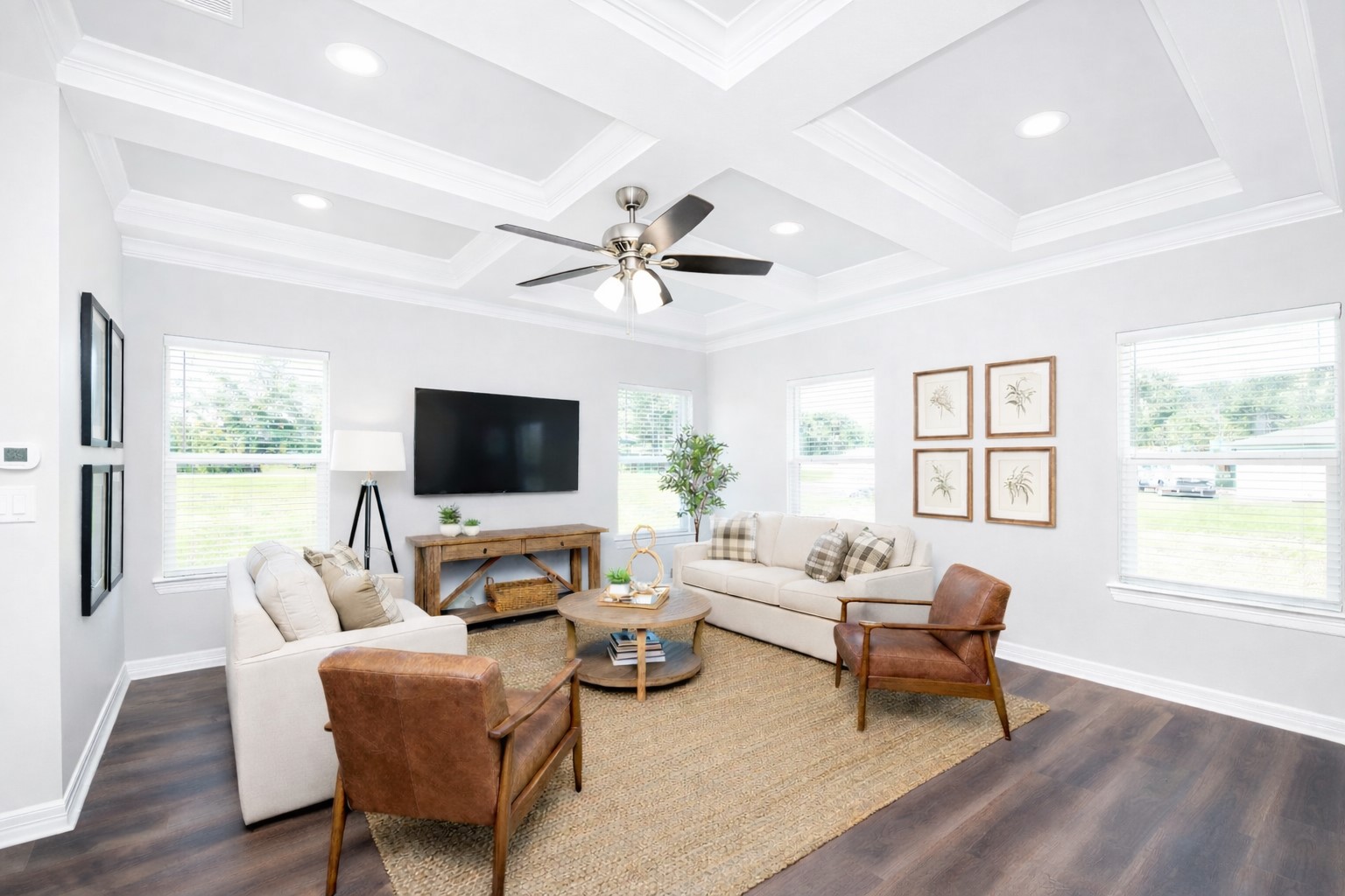 414 North 4th Street Beasley, TX 77417 - Photo 6 of 26 The family room offers a bright and inviting atmosphere, highlighted by durable LVP flooring, recessed lighting, and an elegant tray ceiling for added architectural detail. Expansive windows fill the space with natural light, creating a warm and welcoming environment perfect for everyday living - virtually staged.