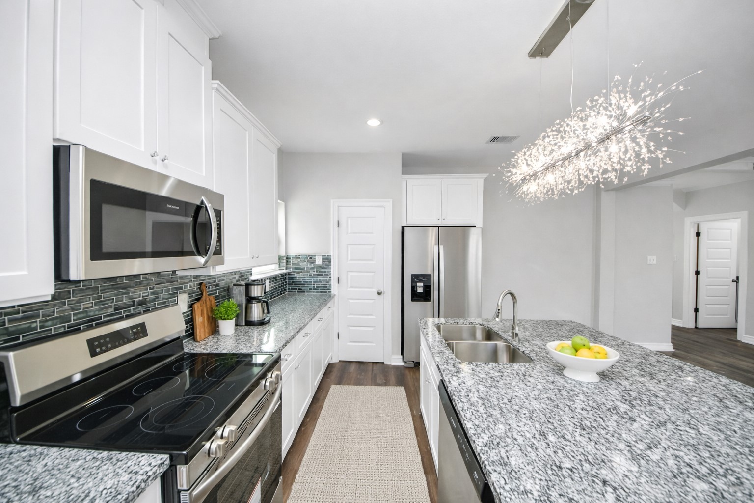 414 North 4th Street Beasley, TX 77417 - Photo 9 of 26 This beautifully designed kitchen offers an abundance of counter and cabinet space, providing plenty of storage to keep everything organized and within reach. The stylish flooring complements the cabinetry perfectly, creating a seamless and inviting look, while the spacious walk-in pantry ensures you’ll never run out of room for all your kitchen essentials - virtually staged.