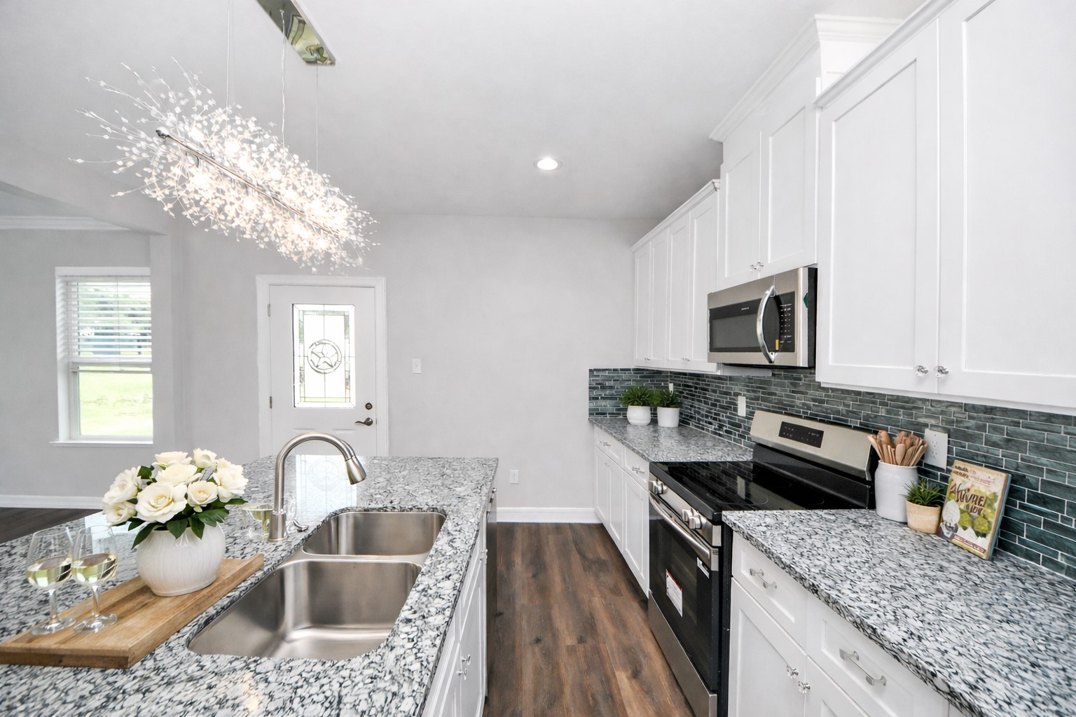 414 North 4th Street Beasley, TX 77417 - Photo 10 of 26 The kitchen is a bright, welcoming space where modern design meets everyday practicality. A beautiful pendant light fixture draws the eye, while ample counter space and cabinetry make it perfect for preparing meals and gathering with family and friends - virtually staged.