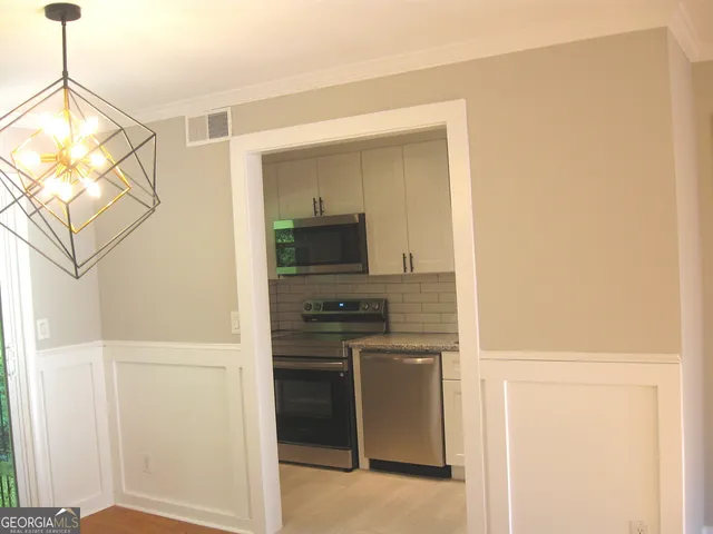 a kitchen with a refrigerator and a stove