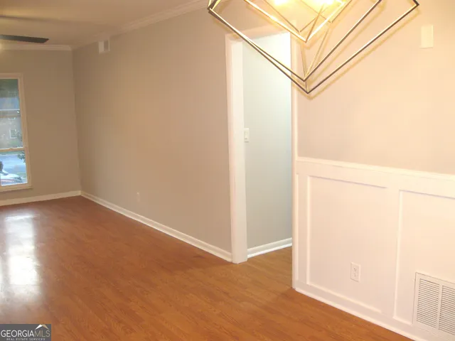 a view of a room with wooden floor