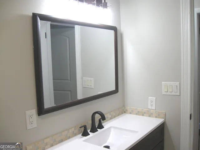 a bathroom with a sink and a mirror