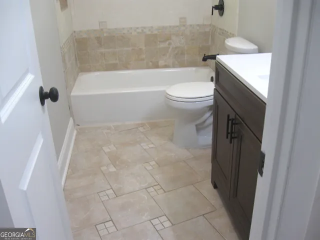 a bathroom with a toilet a sink and bathtub